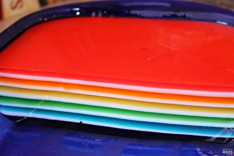 This rainbow jello is stunning and while it looks difficult to make, it's easy! These are easy to follow step-by-step directions! Perfect for your next rainbow party or holiday gathering!