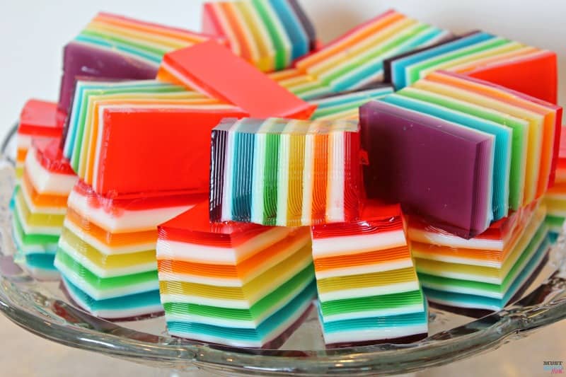 This rainbow jello is stunning and while it looks difficult to make, it's easy! These are easy to follow step-by-step directions! Perfect for your next rainbow party or holiday gathering!