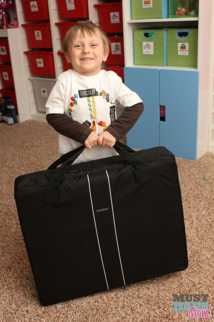 Aiden lifting the BabyBjörn Travel Crib Light