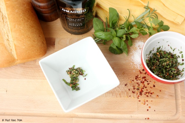 Tuscan Herb Dipping Oil Recipe. SO amazing! Pair with bread for dipping and it tastes like the herb oil you get at fancy restaurants. Easy entertaining idea or hostess gift!