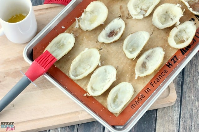 Homemade potato skins with cheddar and bacon. Perfect game day food, appetizer or side dish! These are so delicious they never last long at my house!