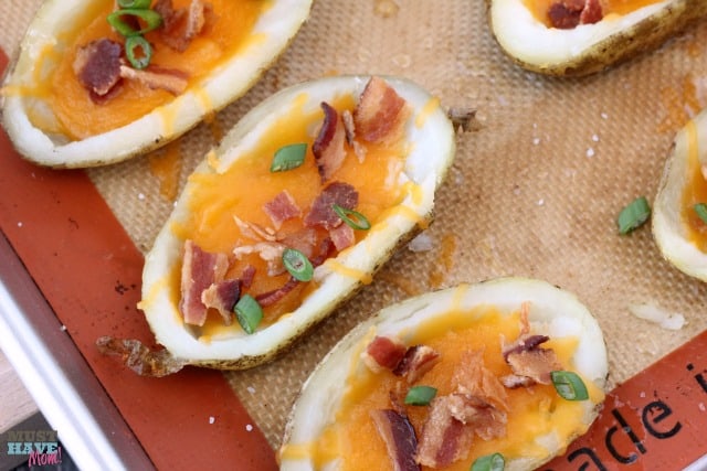 Homemade potato skins with cheddar and bacon. Perfect game day food, appetizer or side dish! These are so delicious they never last long at my house!