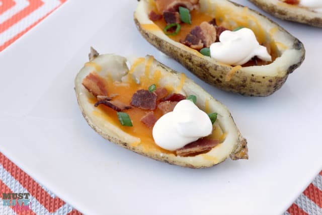 Homemade potato skins with cheddar and bacon. Perfect game day food, appetizer or side dish! These are so delicious they never last long at my house!