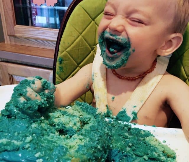 baby eating birthday cake