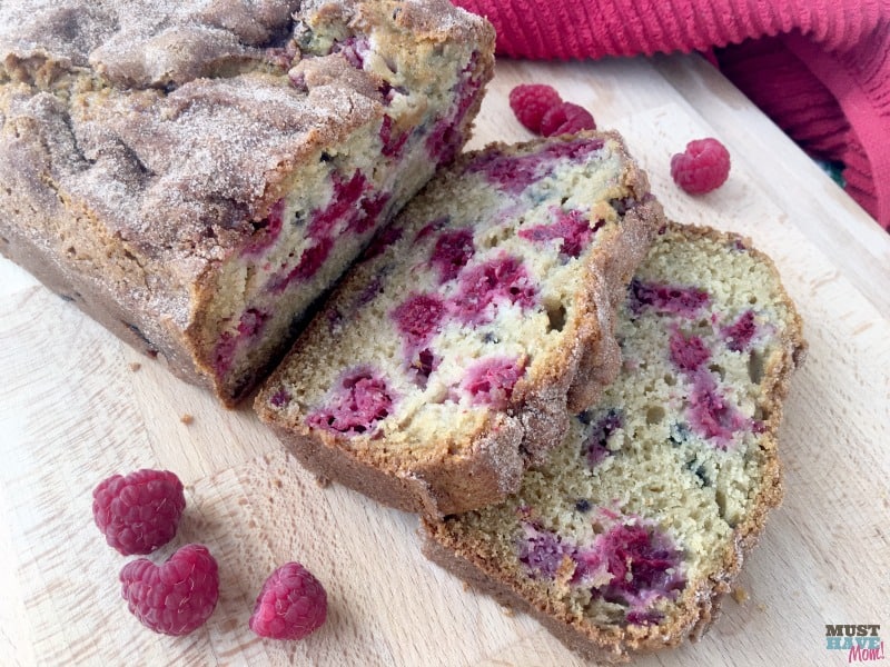 The best summer raspberry bread ever! Moist, mouth-watering berries nestled in a cinnamon sugar topped quick bread.