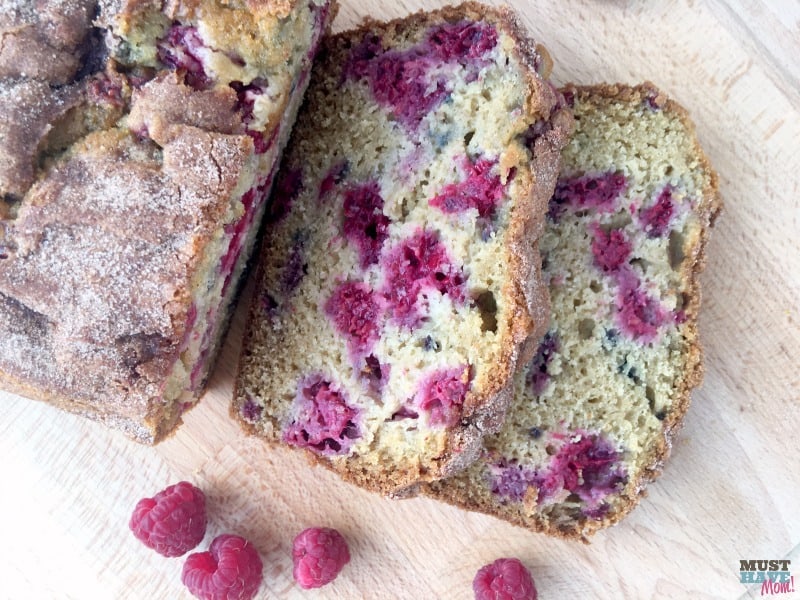 The best summer raspberry bread ever! Moist, mouth-watering berries nestled in a cinnamon sugar topped quick bread. 