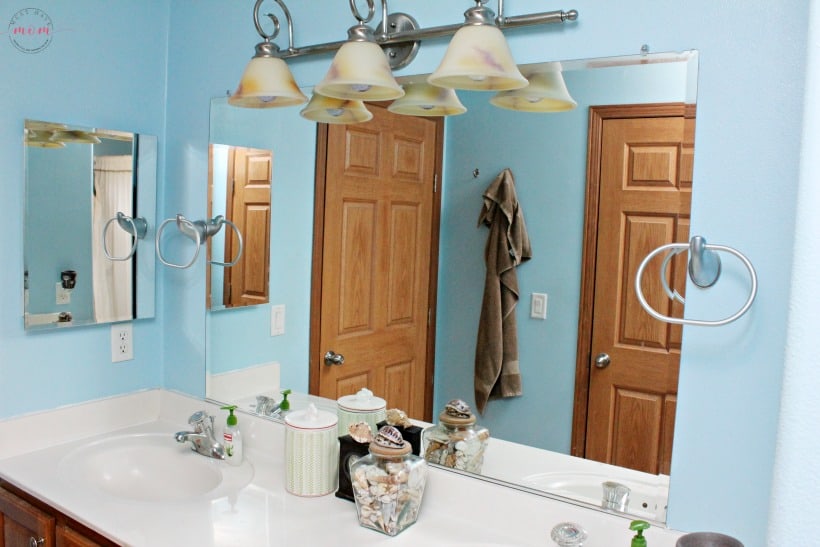 Builder grade bathroom mirror makeover. How to make a DIY bathroom mirror frame.