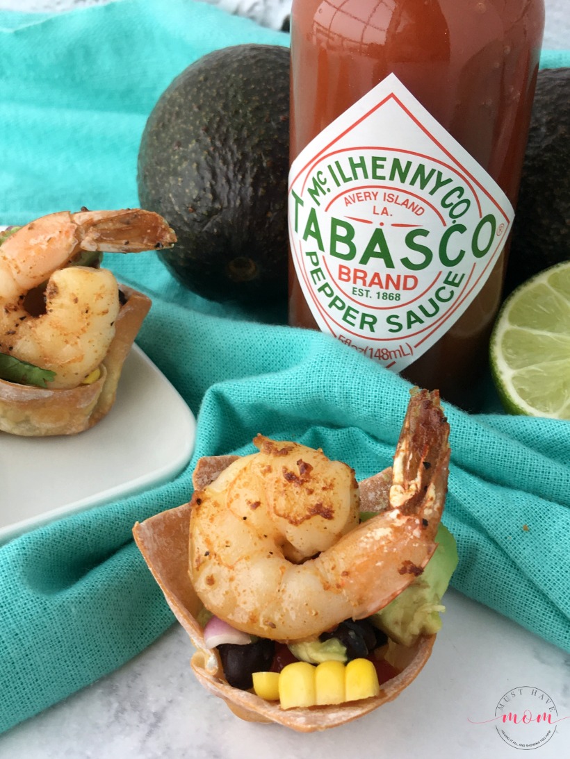 Spicy shrimp wonton cups with black bean corn avocado guacamole. Great party appetizer for the big game!