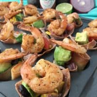 Spicy shrimp wonton cups with black bean corn avocado guacamole. Great party appetizer for the big game!