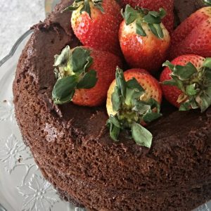 Paleo chocolate cake recipe! Layered chocolate cake topped with strawberries. With superfood addition that my kids love!