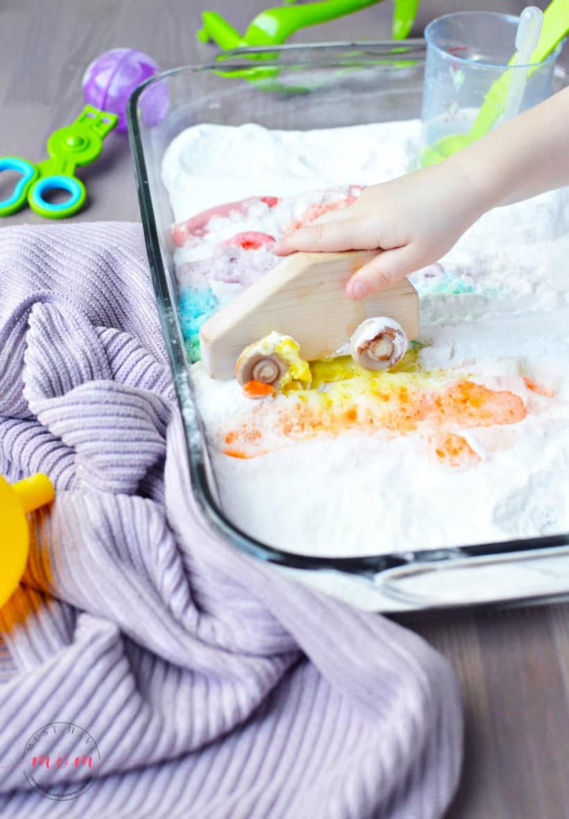 playing in rainbow jello sensory bin