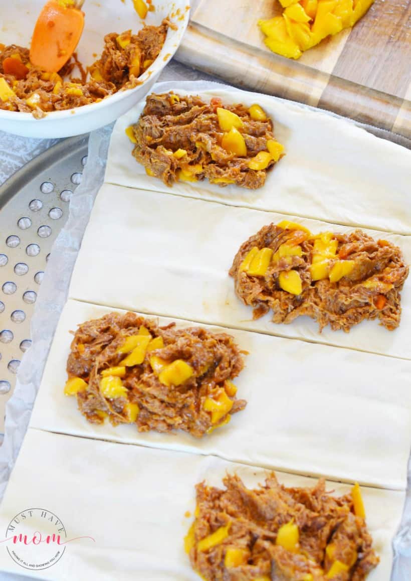 place pulled pork and mango on open face pastry