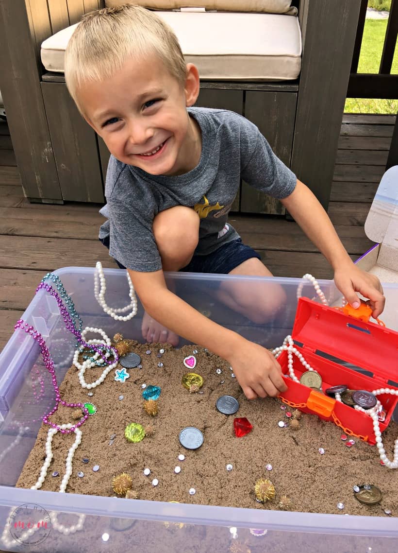 playing treasure hunt sensory bin