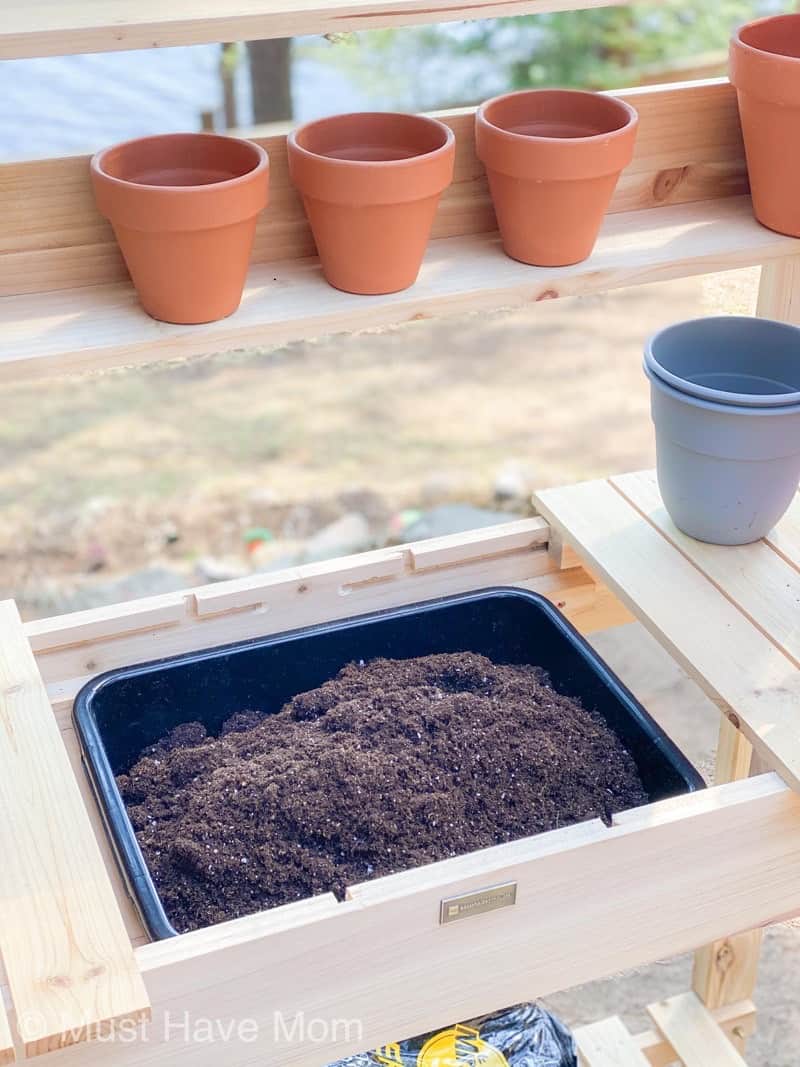 Potting bench deals with soil bin