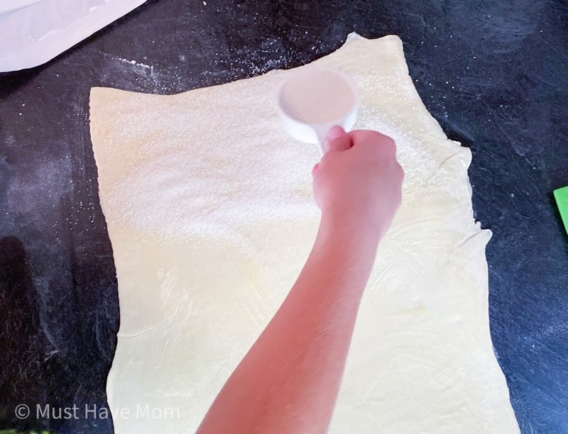 sprinkle sugar on pastry dough