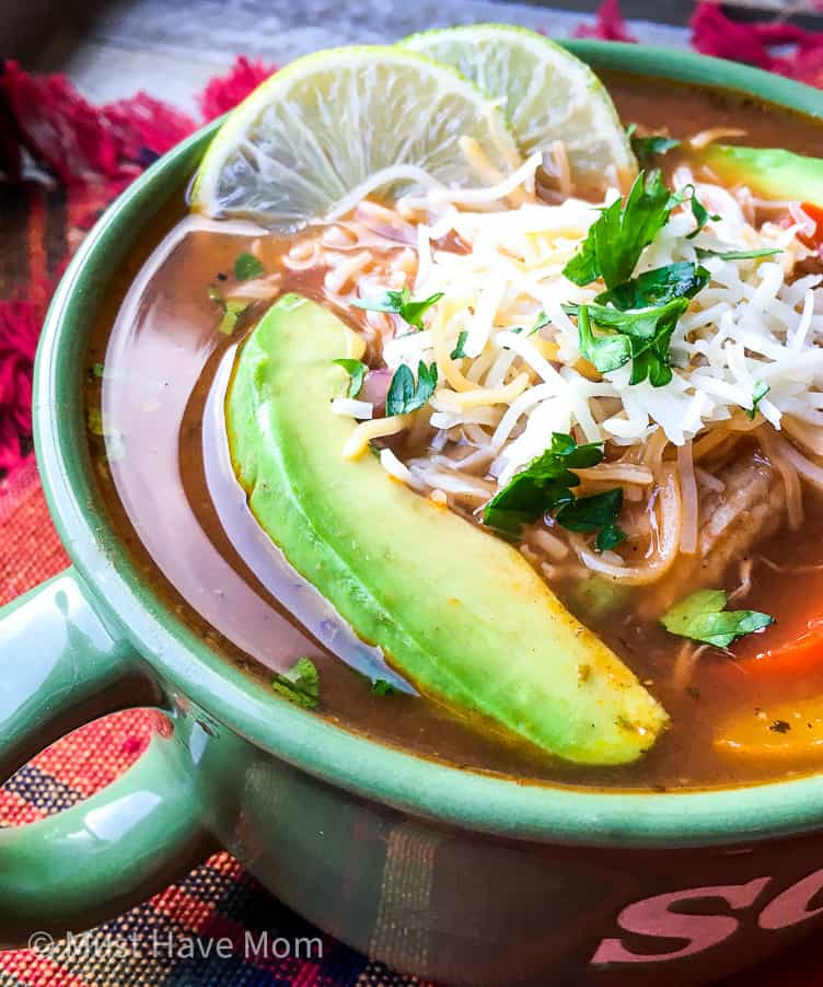 chicken fajita soup with avocado cheese and lime