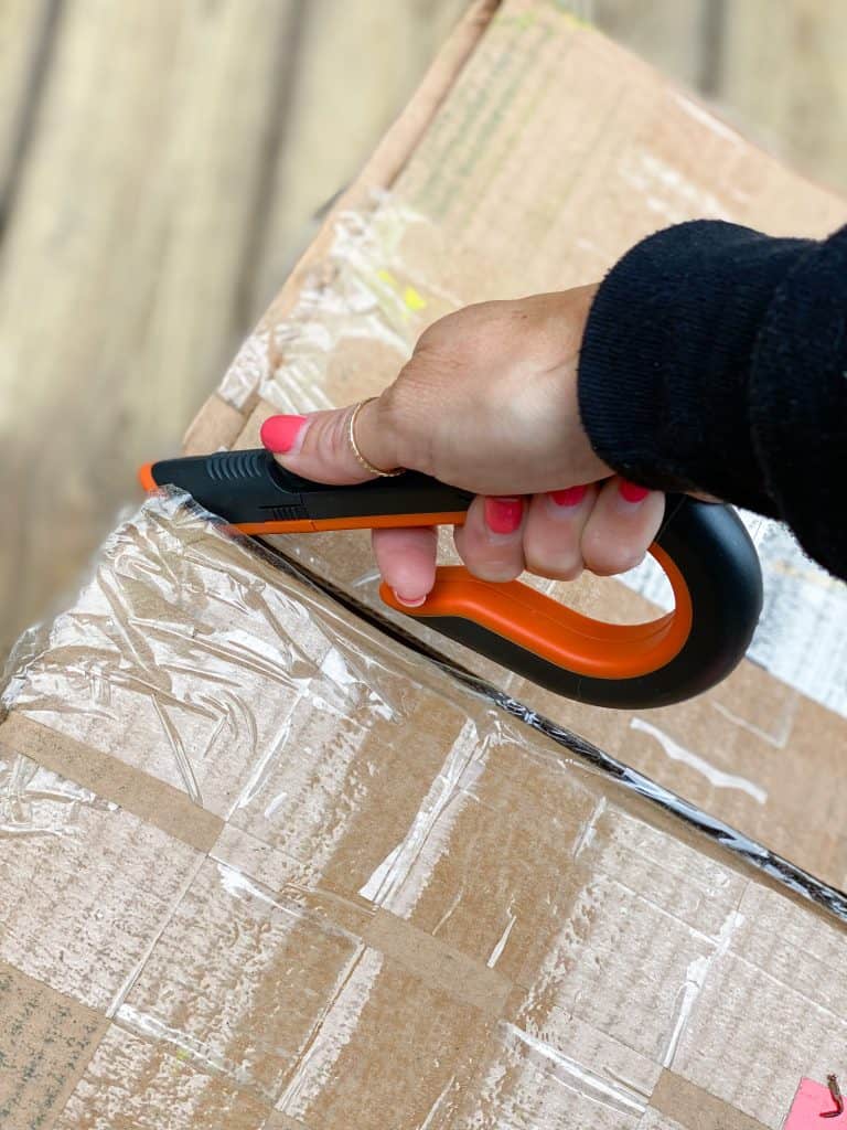 cutting open a box with ceramic blade box cutter