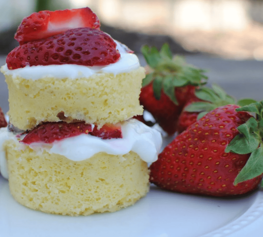 two strawberry mug cakes stacked on top of each other.